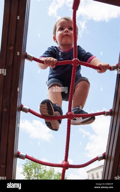 Portrait Of Child Climbing Ropes In A Playground Stock Photo Alamy