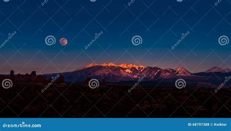 Full Moon Rising Above La Sal Mountains Arches National Park Stock