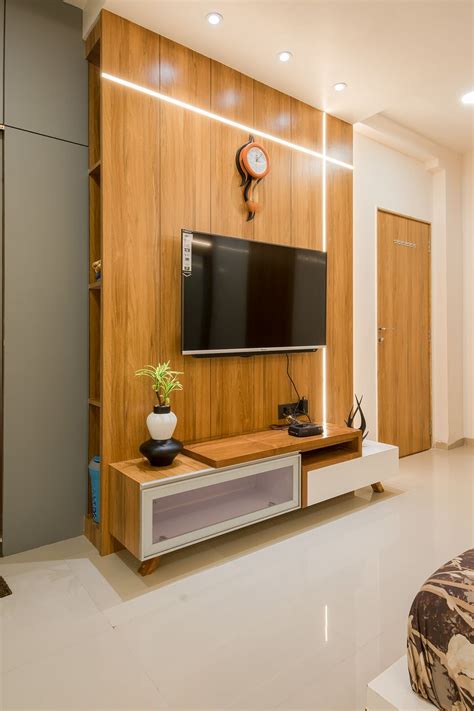 A Living Room With A Flat Screen Tv On The Wall