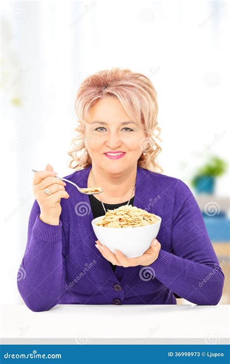 Mature Woman Eating Cereal On A Table At Home Stock Image Image Of Interior Inside 36998973
