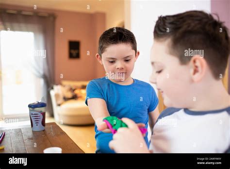Boy With Down Syndrome And Brother Playing Stock Photo Alamy