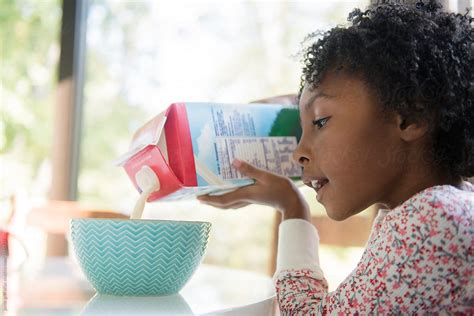 Girl Pouring Milk Into Breakfast Cereal By Stocksy Contributor Jamie Grill Atlas Stocksy