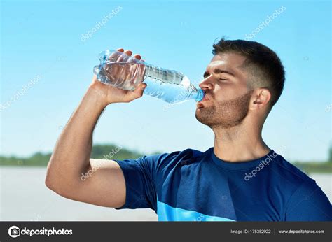 Man Drinking Water After Running Portrait Stock Photo By ©puhhha