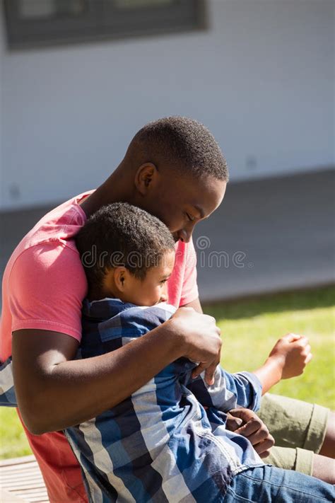 Father Embracing His Son In The Backyard Stock Image Image Of Love