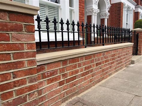 Red Brick London Wall With Stone Effect Caps And Solid Metal Rail
