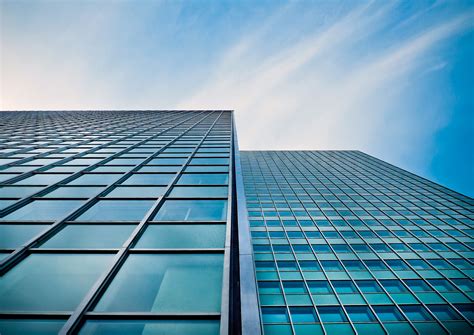 Low Angle View Of Office Building Against Blue Sky · Free Stock Photo