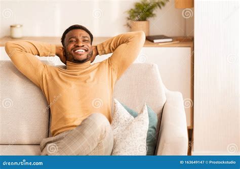 Relaxed African American Man Resting Sitting On Couch At Home Stock Image Image Of Leaning