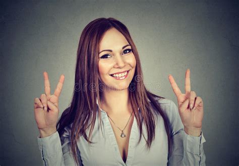 Woman Or Teenage Girl Showing Peace Hand Sign With Both Hands Stock
