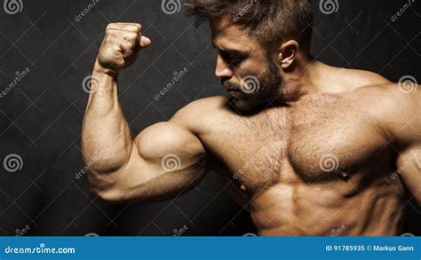 Muscular Man Flexing His Muscles With A Bare Chest Royalty Free Stock