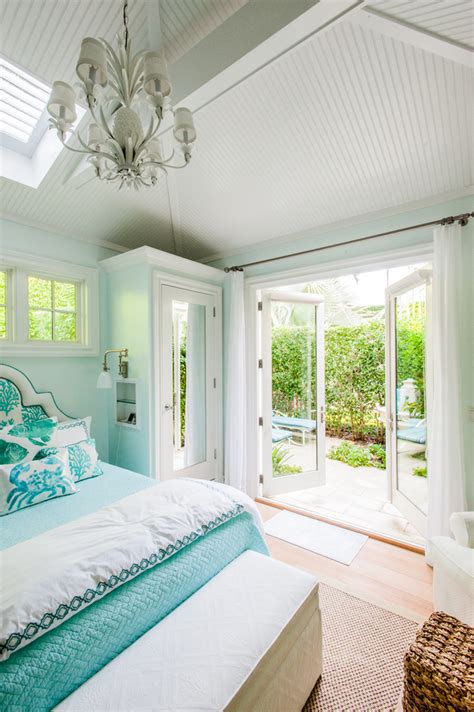 This turquoise baby's room is covered in flowered wallpaper. Sciame Homes | House of Turquoise