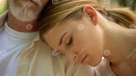 Upset Granddaughter Lying On Grandpas Shoulder Hiding From Problems