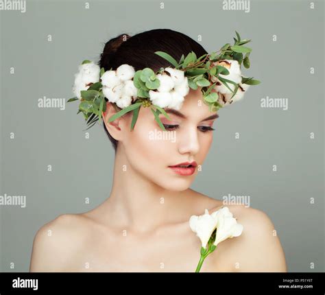 Young Spa Model Woman With Clear Skin Cotton Flowers And Green Leaves
