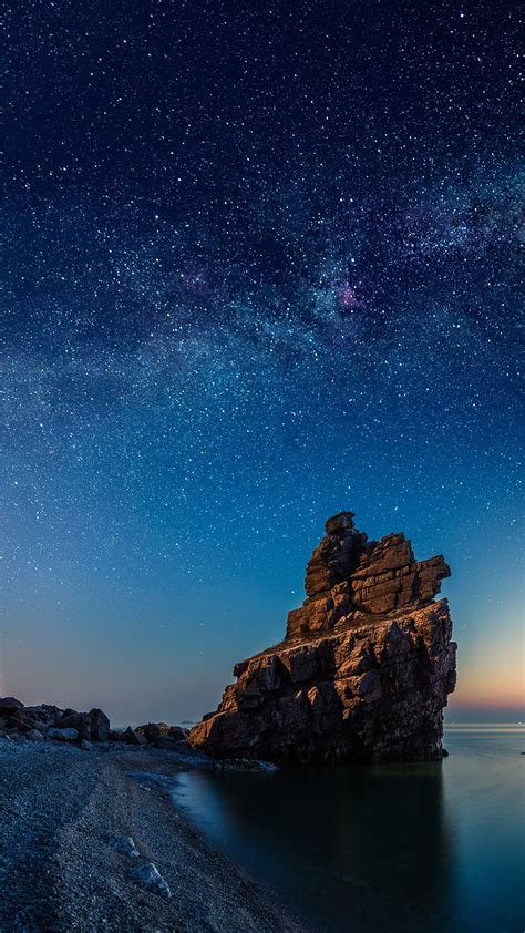 Starry night over rock formations by the Pacific Ocean, Dalian 