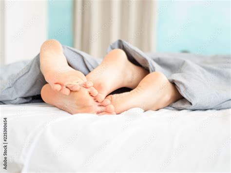 Close Up Of Feet Couple Sleeping On A Bed At Home Feet Of Couple In