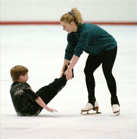 Two People On Ice Skates One Is Holding The Other S Leg