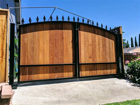 You don't have to stay with a boring fence if you. Wooden Driveway Gate Kit | Arched, Wrought Iron, Ironwood ...