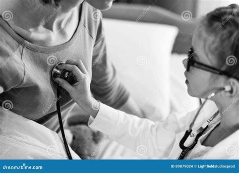 Little Girl Doctor With Stethoscope Listening Heartbeat Of Patient