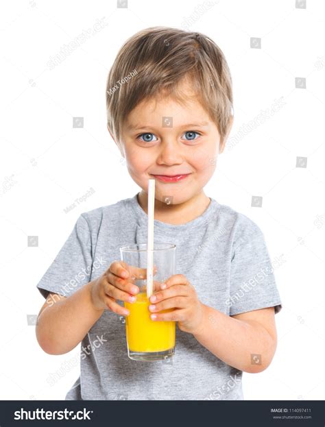 Portrait Of Happy Little Boy Drinking Orange Juice Isolated Over White