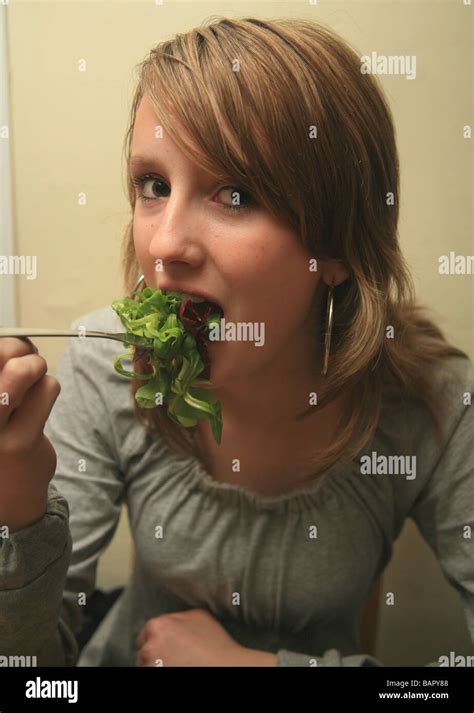 Teenage Girl Eating Salad Stock Photo Alamy