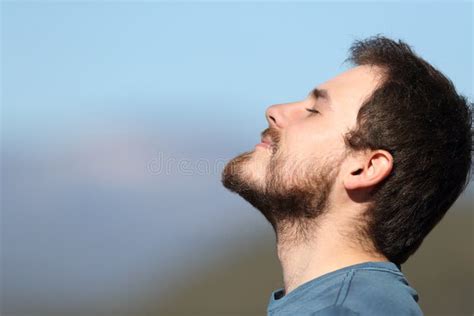 Close Up Portrait Of A Man Breathing Fresh Air Outdoors Stock Photo