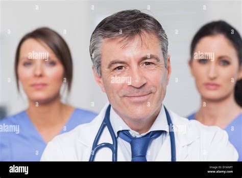 Smiling Doctor With Two Nurses Stock Photo Alamy