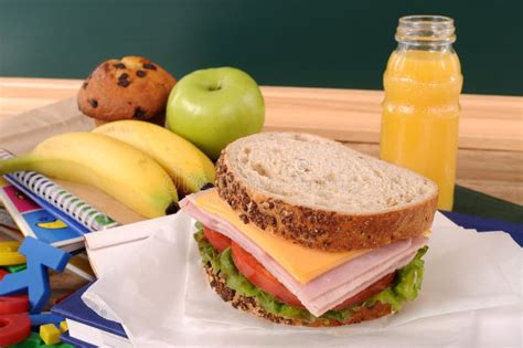 School Packed Lunch Ham And Cheese Sandwich On Classroom Table Or Desk
