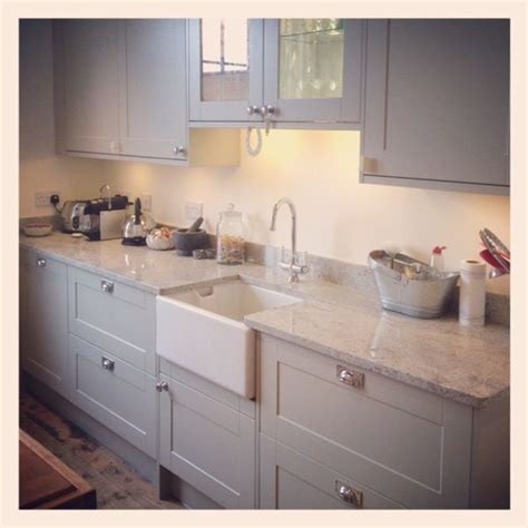 Beautiful, two tone light wood gray island seating hood wood floor. Painted light grey wood kitchen with marble worktops and ...