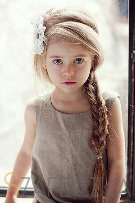 Beautiful Little Girl With A Long Blonde Braid And A White
