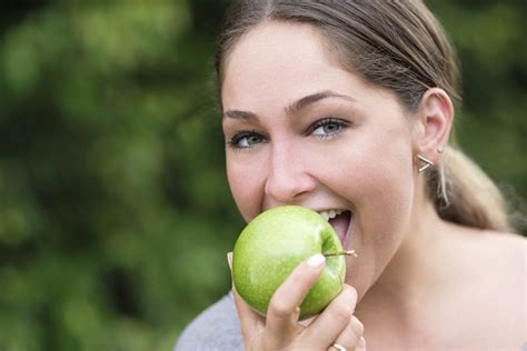 Portrait Of Woman Eating Green Apple Stockfreedom Premium Stock