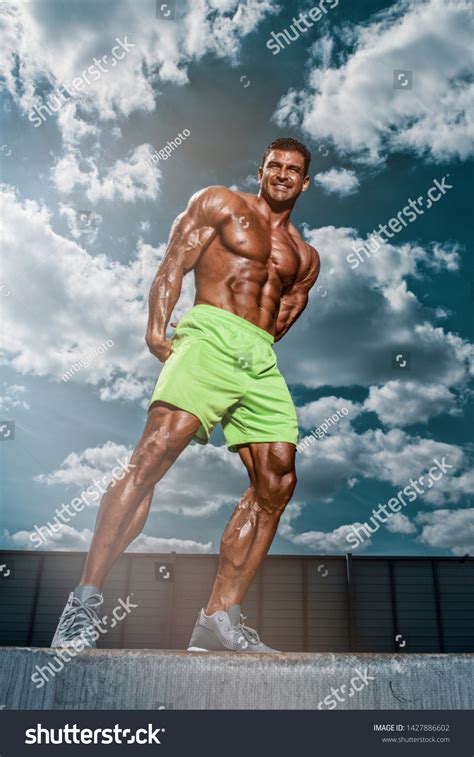 Handsome Muscular Men Flexing Muscles Outdoors Stock Photo 1427886602