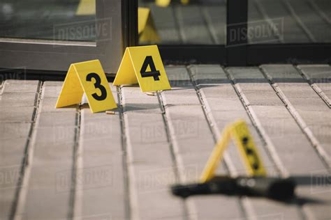 Blurred Close Up View Of Crime Scene With Gun And Numbers Stock Photo