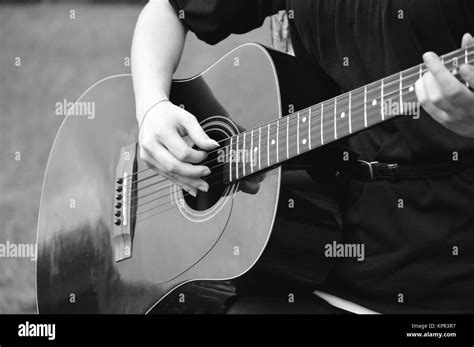 Black And White Photo Of Guitarist Playing Acoustical Guitar Stock