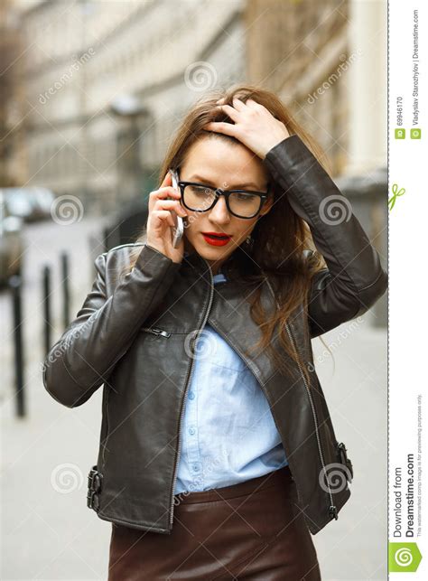 Businesswoman On Cellphone Walking Down The Street While Talking Stock