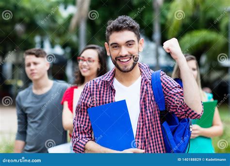 Successful Spanish Male Student With Group Of Other Students Stock