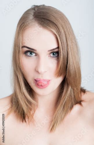 Beautiful Woman Model Sticking Tongue Out As Funny Face Concept Stock