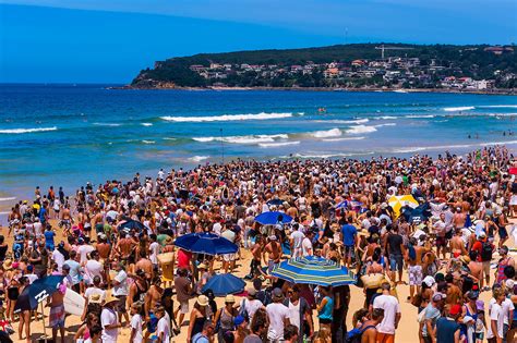 a large crowd on the beach during the australian open of surfing at manly beach sydney new