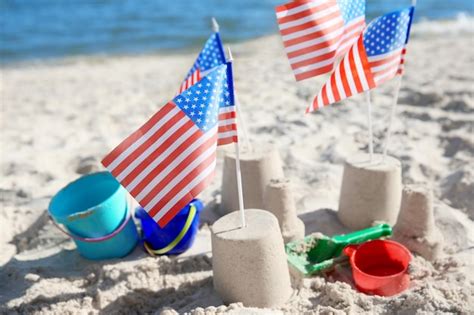 Premium Photo Sand Castle With American Flags On Beach