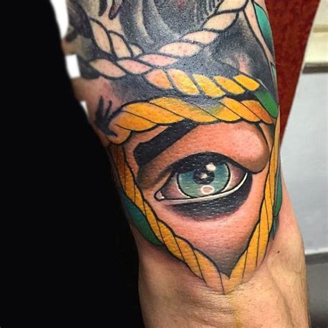 Simple Big Colored Human Eye Tattoo On Arm With Rope Tattooimagesbiz