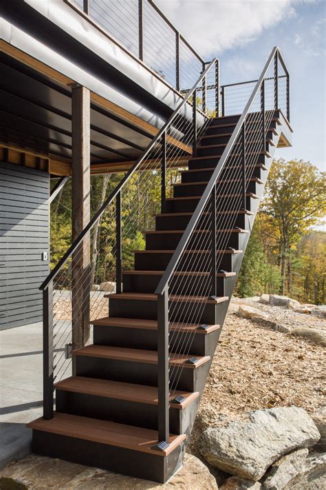 Cable railing is a hybrid of materials, as the cables are installed in frames of wood, aluminum or composite. Black Cable Railing on Deck Stairs | Exterior stairs ...