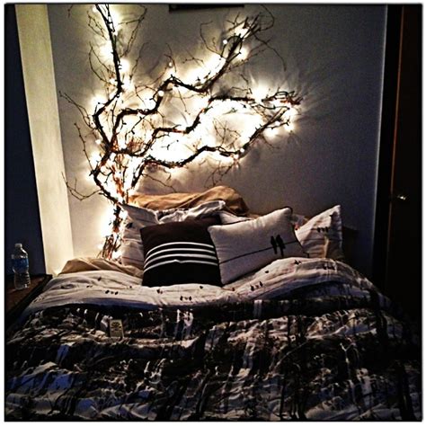 A Bed With Lights On The Headboard And Pillows In Front Of It Is Lit Up