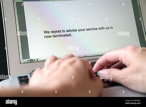 Woman S Hands Typing Letter Of Termination Of Service Words Appear On The Computer Screen Stock