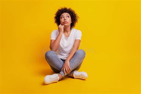 Portrait Of Young Woman Pondering Over Something Sit Floor Look Up