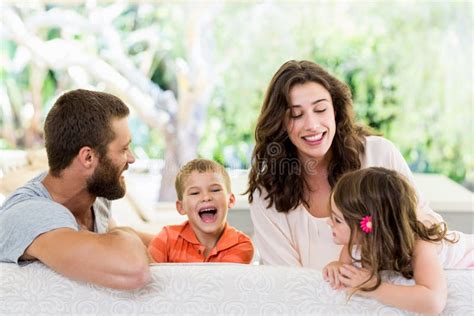 Parents Having Fun With Their Kids Fun In Living Room Stock Photo