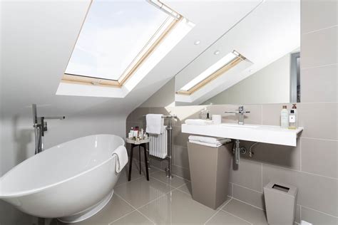 Get small bathroom design ideas that will make a big splash in even the tiniest spaces. Grey tiled loft conversion bathroom with beautiful free ...