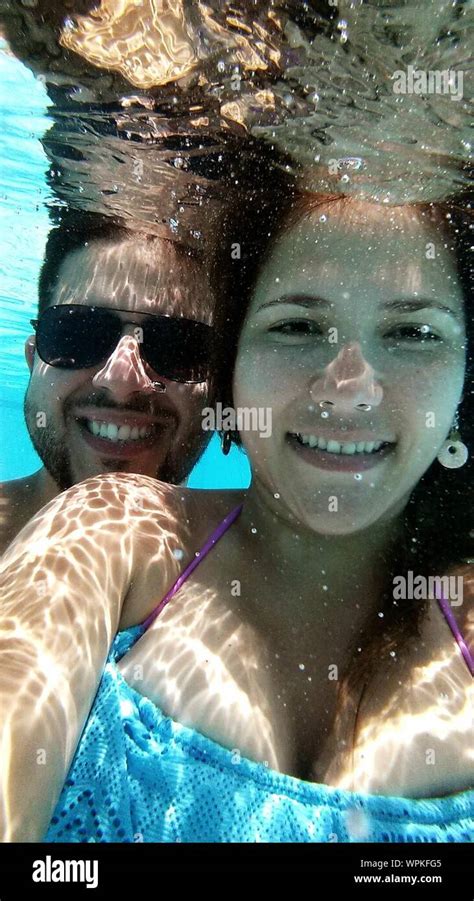 Portrait Of Smiling Couple In Swimming Pool Stock Photo Alamy