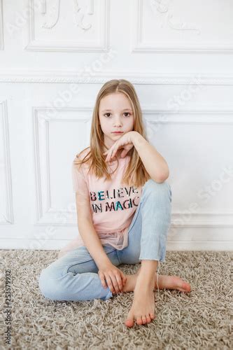 Cute Pre Teen Girl Wearing Fashion Clothes Posing In White Interior