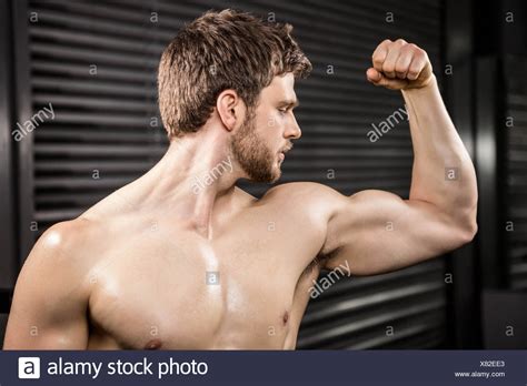Male Bodybuilder Flexing His Biceps High Resolution Stock Photography