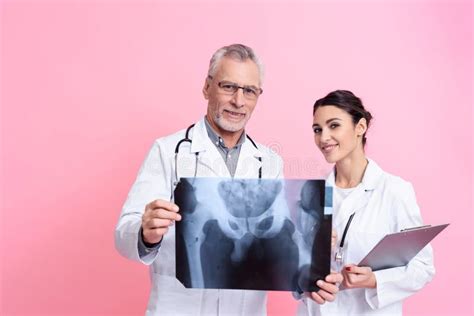 Portrait Of Male And Female Doctors With Stethoscopes Holding X Ray And
