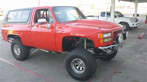 A Red Pick Up Truck Parked In A Parking Lot