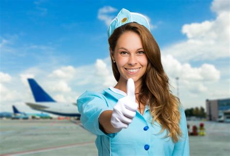 Cabin crews with more than 20 years of experience earn £27,000 on average. Smiling hostess thumbs up - FlightDeckFriend.com